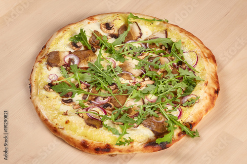 Fresh baked pizza with mushrooms on wooden background