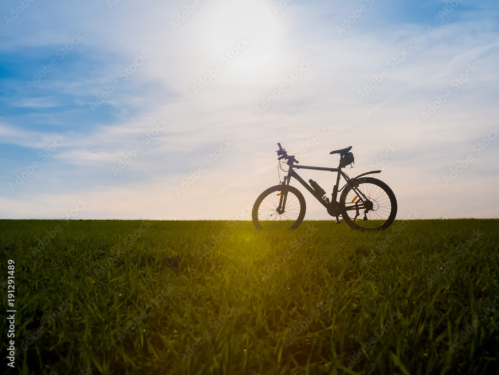 Bicycle silhouettes on the dark background of sunsets