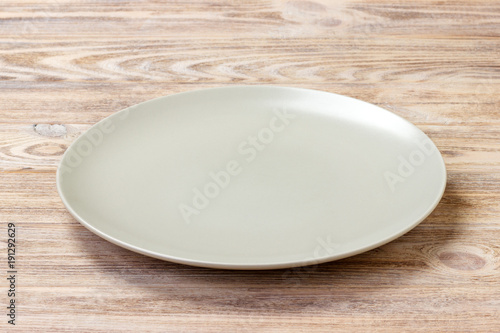 empty round plate for food on wood bachground. Perspective view