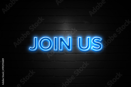Join Us neon Sign on brickwall