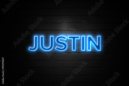 Justin neon Sign on brickwall photo