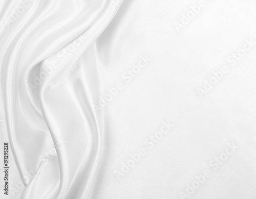 Smooth elegant white silk or satin luxury cloth texture as wedding background. Luxurious Christmas background or New Year background design