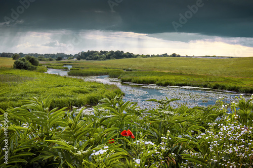 Bild auf Leinwand summer landscape with a river and thunderclouds, open countryside