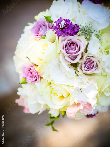 the bridal bouquet with white and pink roses in the sunshine