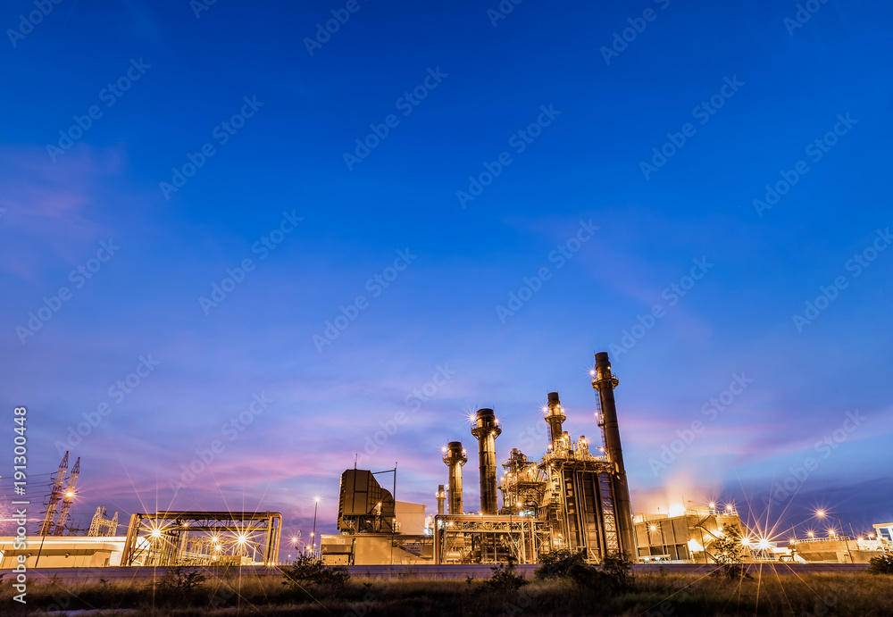 Gas combine electrical power plant at dusk with blue sky is support all factory in industrial estate
