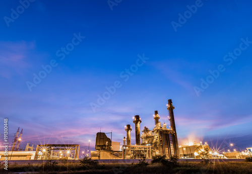 Gas combine electrical power plant at dusk with blue sky is support all factory in industrial estate 