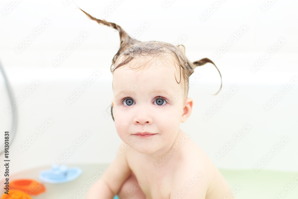 Happy little 1 years girl taking bath and playing toys Happy little 1 years girl taking bath and playing toys