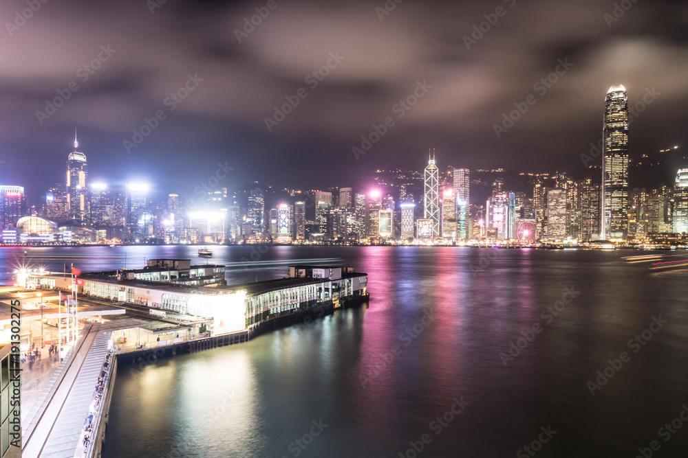 Stunning view of Hong Kong island skyline and the Star ferry pier in Kowloon at night