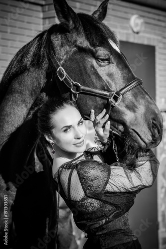  Portrait of happy beautiful nice woman and brown horse near the horse farm. Concept people and animals. Girl with an horse together at the horse house   © T.Den_Team