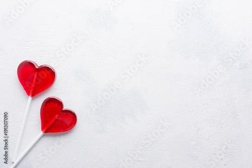 Two red Candy hearts on white concrete background. Minimal love concept. Romantic Style.  Creative for colorful greeting card with copy space.