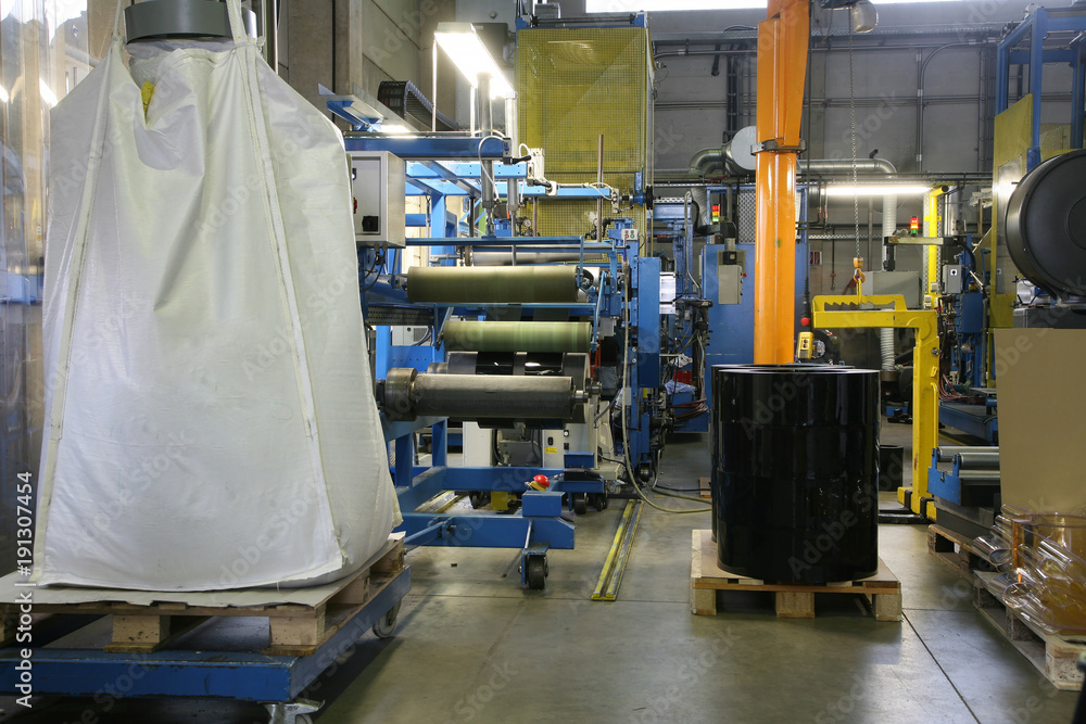 Fototapeta premium factory shop production of polyethylene film mechanisms machine tools lifting mechanism wires hoses switches pressure gauges pressure temperature molten mass work place enterprise