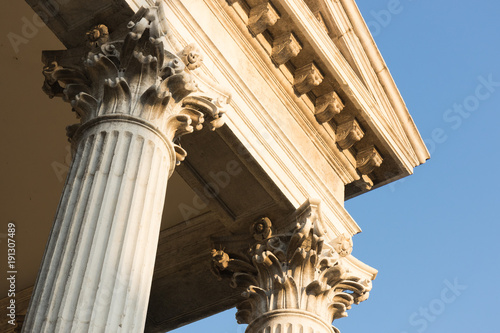 A look from a low angle onto the columns and the cornice of the old Venetian church