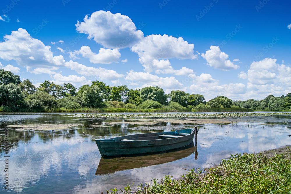 summer landscape: a river  reflect white curly clouds, on  river boat