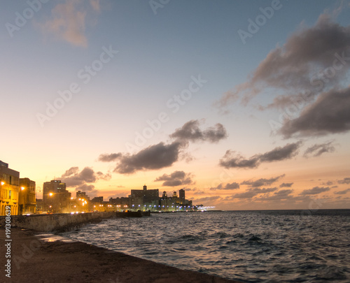 Sunset at Malecon, the famous Havana promenades. Cuba. At the bottom of the image, the National Hotel. © Toniflap