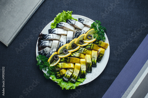 Herring and mackerel sliced on a plate beautifully laid out photo
