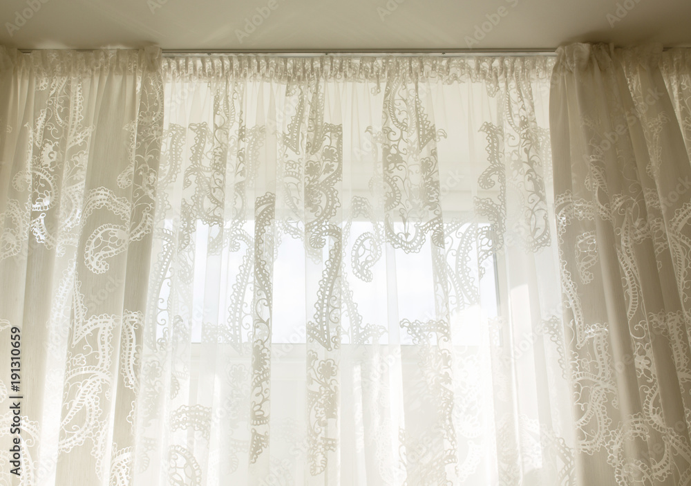 Transparent tulle curtain in room with window Transparent tulle curtain in room with window