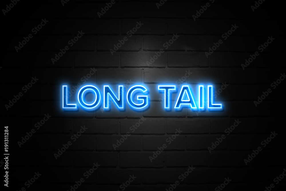 Long Tail neon Sign on brickwall Long Tail neon Sign on brickwall