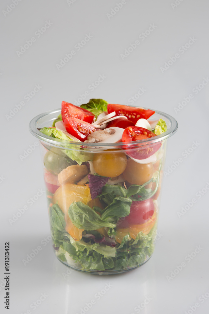 a small fresh salad in a plastic container of a snack food truck or take away a small fresh salad in a plastic container of a snack food truck or take away