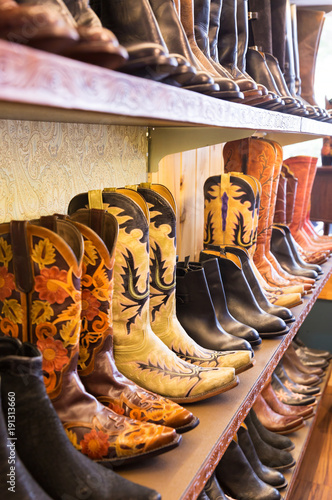 Cowboys boots on a shelf in a store, aligned