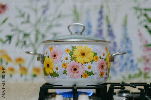 Elegant flower kitchen for workshop cooking with flower pan in hotel have a equipment luxury and closeup pot on the gas stove which has fire.