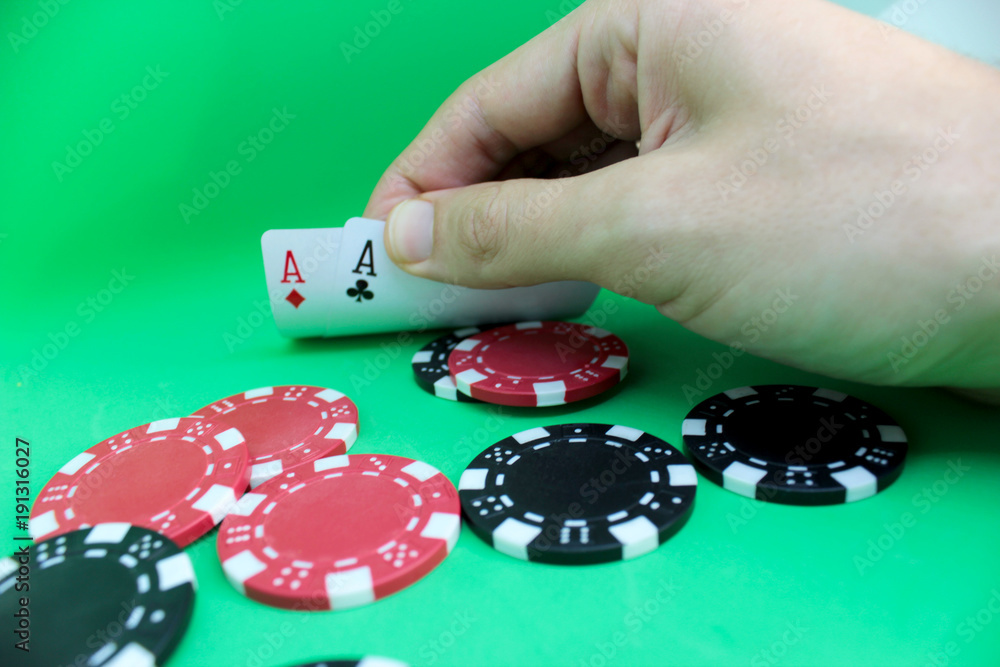 Man's hand holds a poker cards. Poker concept on black background. Close up. Man's hand holds a poker cards. Poker concept on black background. Close up.