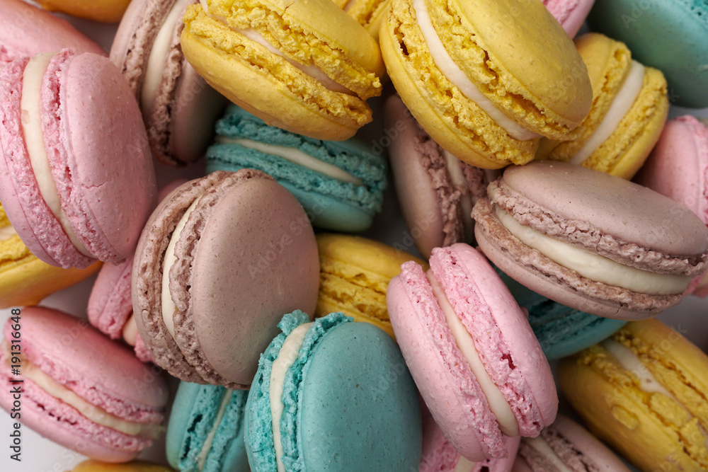 Pink, beige and blue macaroons, flat lay style. Colorful almond cookies. Pastel cake macarons background. Pink, beige and blue macaroons, flat lay style. Colorful almond cookies. Pastel cake macarons background.