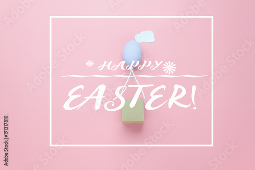 Top view shot of arrangement decoration Happy Easter holiday background concept.Flat lay colorful Easter egg balloon flying transfer gift box on sky pink paper with cloud at office desk.pastel tone.