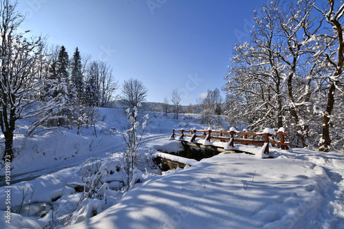 Snowy, wooden bridge in a winter day.