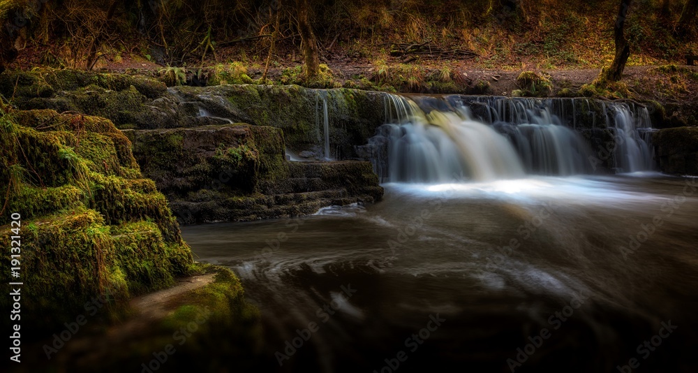 Fototapeta premium Afon Pyrddin waterfall Pontneddfechan A small waterfall on the Afon Pyrddin river en route to Sgwd Gwladus aka Lady Falls near Pontneddfechan, South Wales, UK, known as Waterfall Country