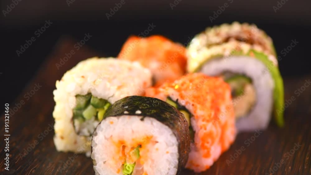 Sushi rolls set rotated over black background. Japanese restaurant sea food menu. 4K UHD video footage. 3840X2160 Sushi rolls set rotated over black background. Japanese restaurant sea food menu. 4K UHD video footage. 3840X2160