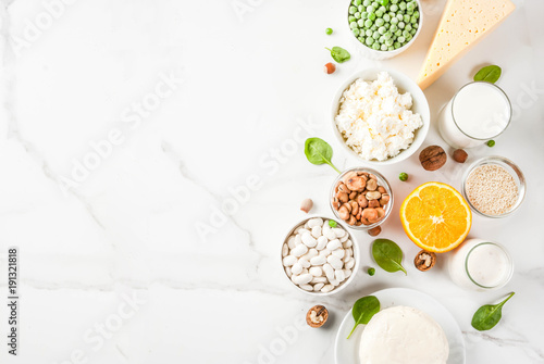Healthy food concept. Set of food rich in calcium - dairy and vegan Ca products, white marble background top view copy space photo