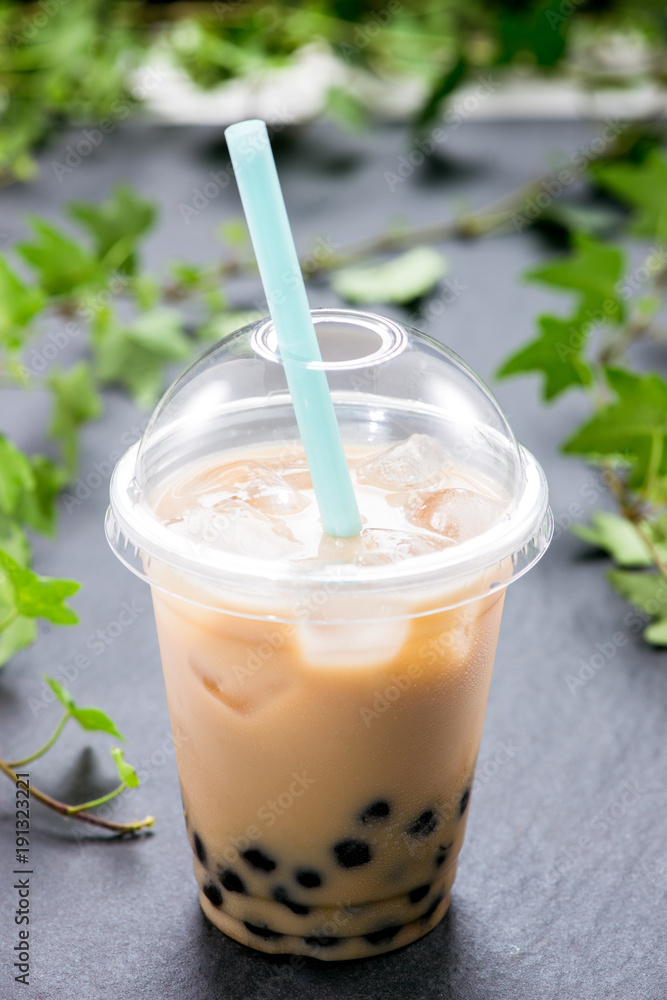 Homemade milk bubble tea in plastic cups on table. Homemade milk bubble tea in plastic cups on table.