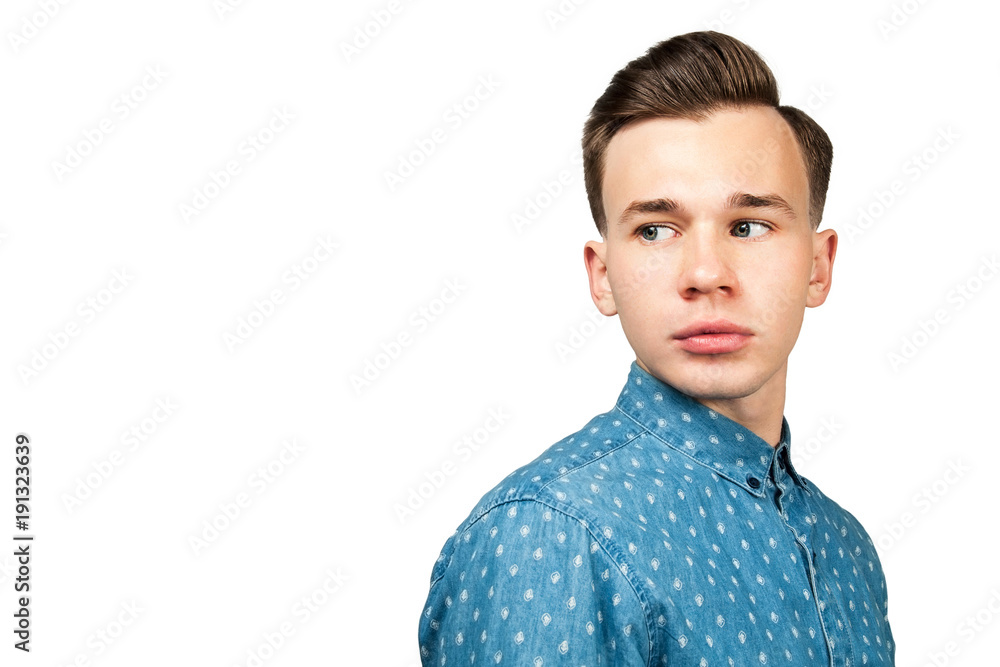 Handsome white young man in blue shirt looking over the shoulder, isolated on white background Handsome white young man in blue shirt looking over the shoulder, isolated on white background
