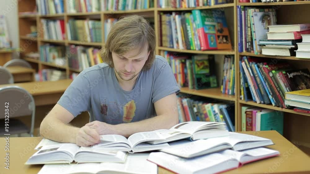 Man in library reads a lot of books. He is terrified by the amount of info. I will never make it too much to study Man in library reads a lot of books. He is terrified by the amount of info. I will never make it too much to study