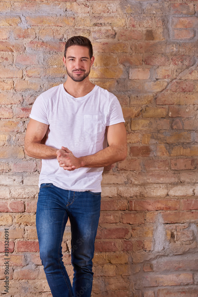 Portrait of a happy handsome young man in a white tshirt. Portrait of a happy handsome young man in a white tshirt.