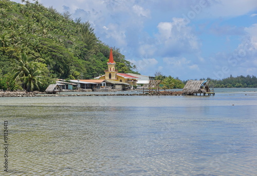 Huahine island church and fishing trap of Maeva village on the shore of the saltwater lake Fauna Nui, French Polynesia, south Pacific
