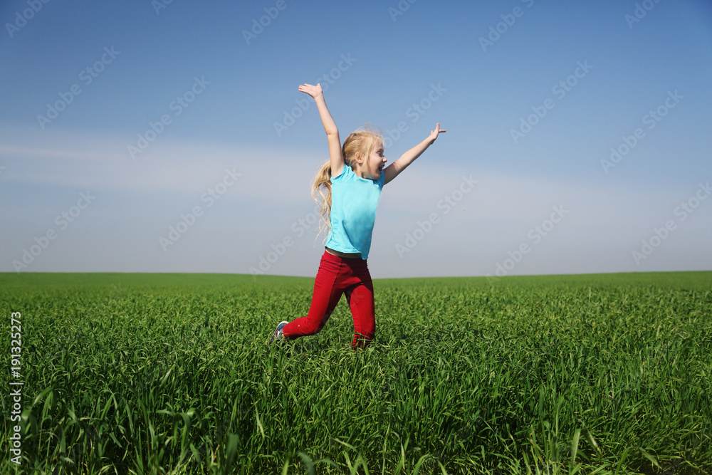 Cute girl jumping in the field Cute girl jumping in the field