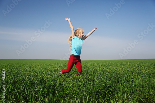 Cute girl jumping in the field