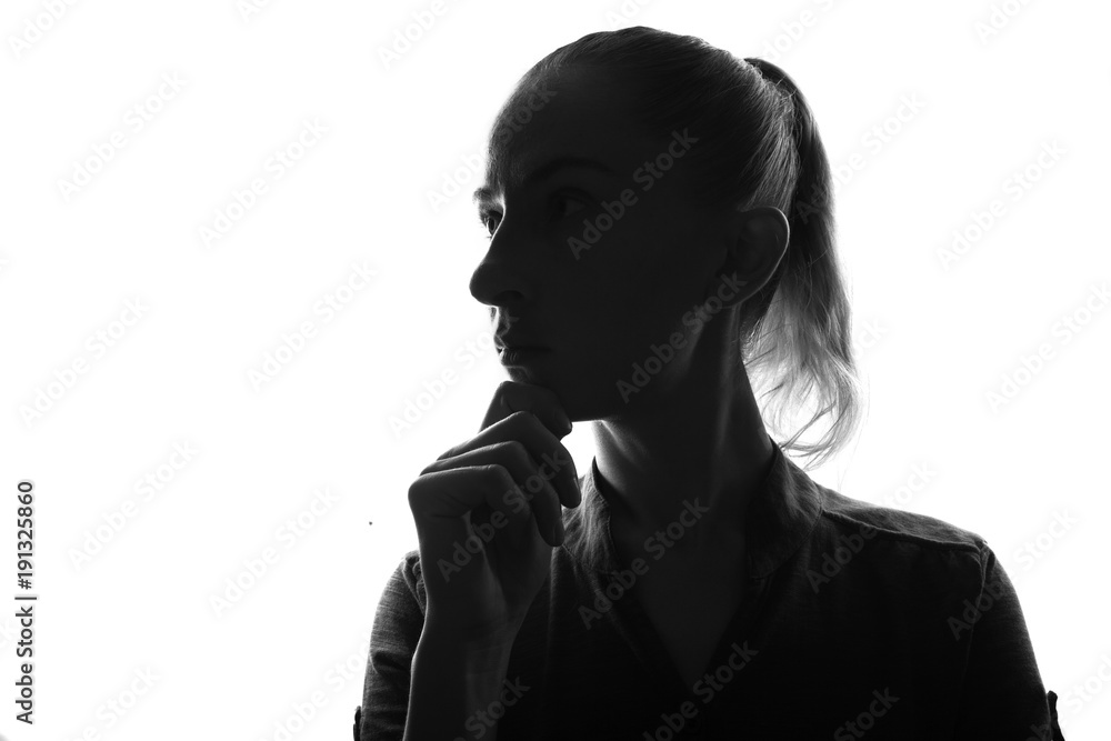 Portrait of thinking woman,back lit isolated on white