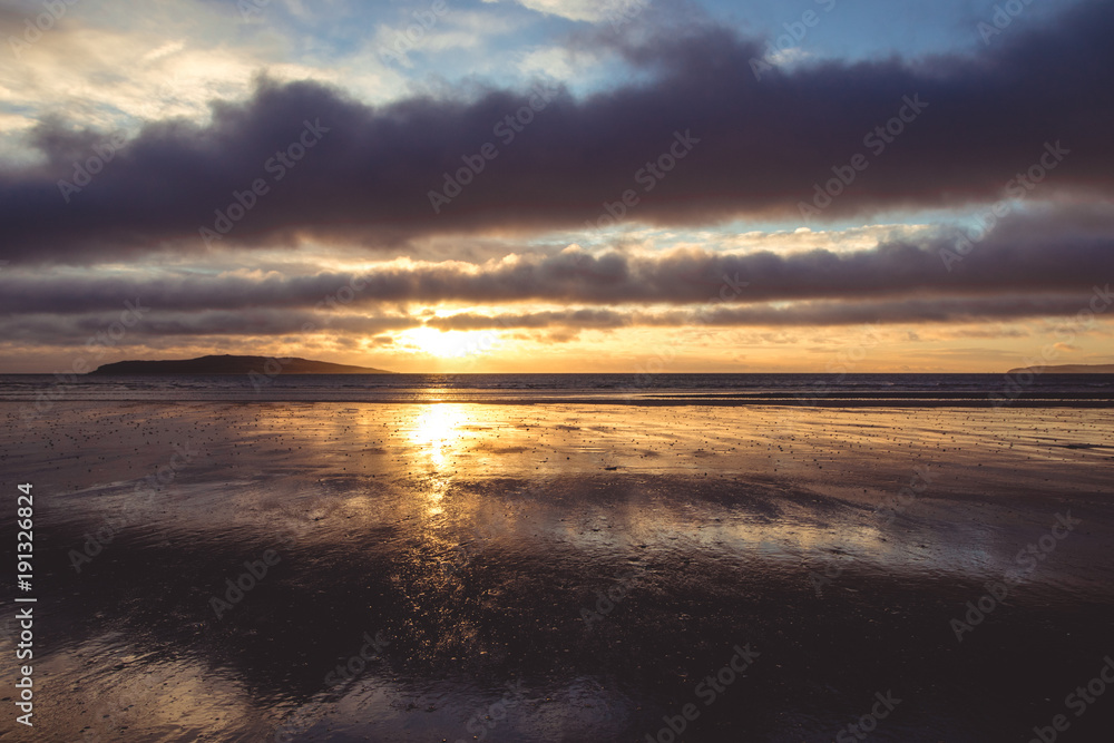 Yellow sunrise on beach in Rush Ireland