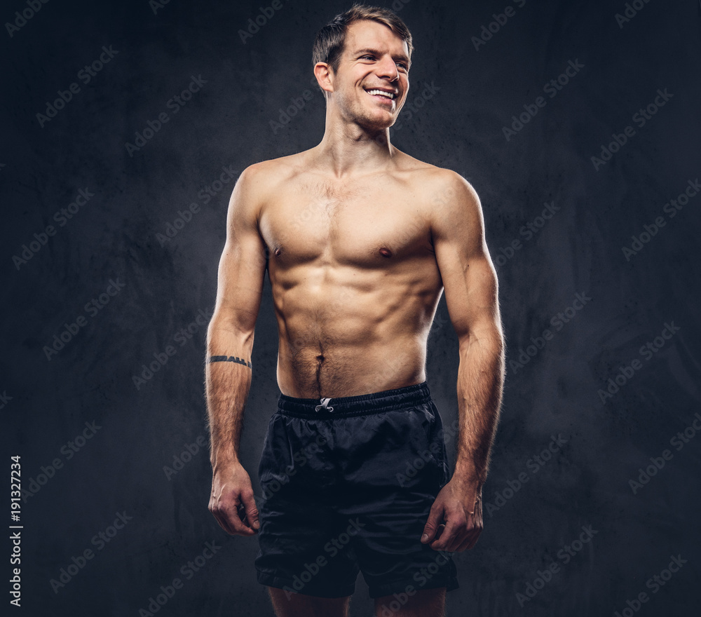 Studio portrait of a shirtless athletic tattooed male