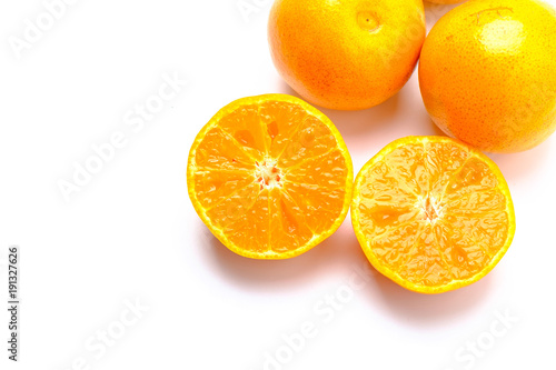 Fresh orange cut in half on a white background.