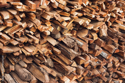 Obraz na plátně Stacks of dry textured firewood closeup. Toned photo.