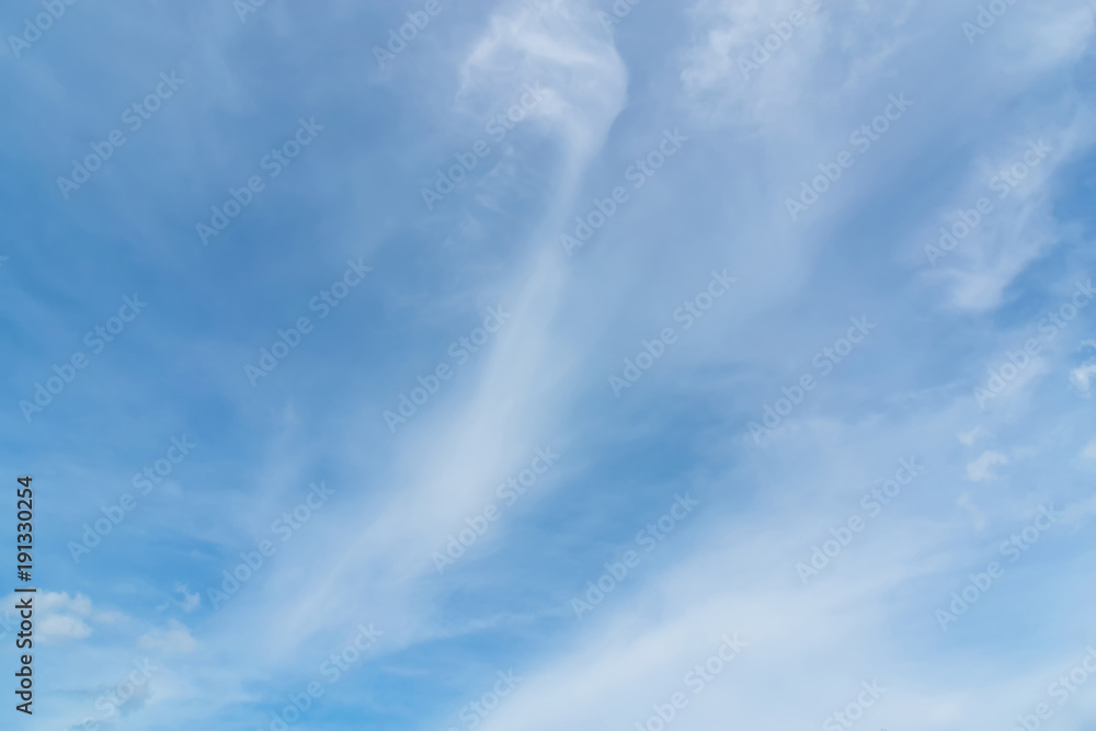 Blue sky background with tiny clouds. White fluffy clouds in the blue sky Blue sky background with tiny clouds. White fluffy clouds in the blue sky