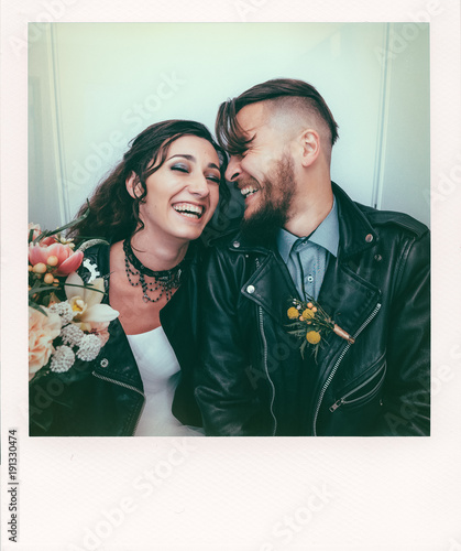 Wedding in the style of rock. Rocker or Biker wedding. Guys with stylish leather jackets. It's a rock'n'roll baby! The sweet couple are photographed in a photobooth. Photo in the style of Polaroid.