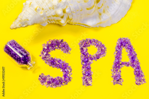 Word spa aroma sea cosmetics salt lavender extract bath natural mineral treatment view close up concept ultra violer color trend year purple yellow background flat lay photo