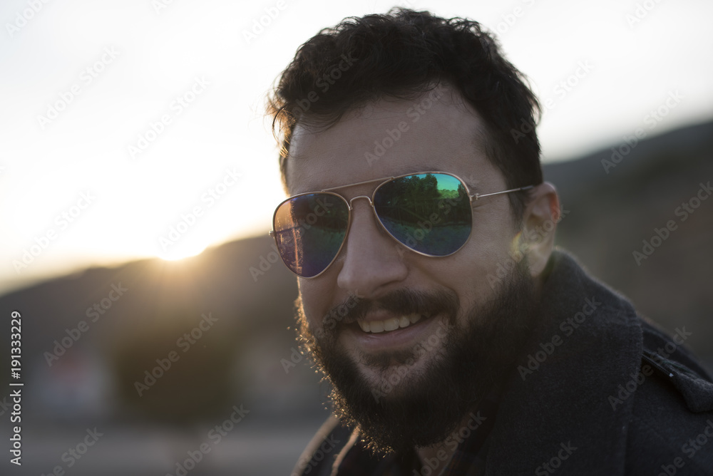Bearded man with sunglasses in sunset image Bearded man with sunglasses in sunset image