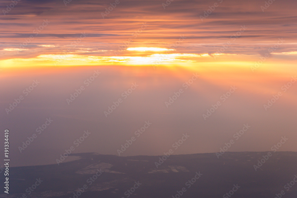 Beautiful view of cloud and sky from the windows of airplane flying when the sunrise
