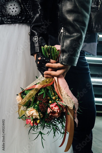 Wedding in the style of rock. Rocker or Biker wedding. Guys with stylish leather jackets. It's a rock'n'roll baby! Sweet couple in a photo studio. Steep shooting with mirrors and lamps.