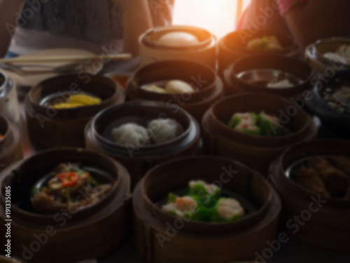 The blurry light design background of Chinese food ,Dimsum in bamboo basket.put on table,at chinese food reataurant.